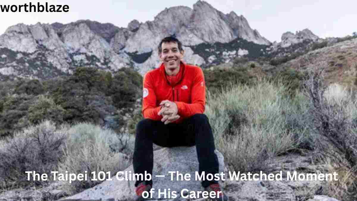 Alex Honnold sitting on a rock in front of a rugged mountain landscape, reflecting on his climbing achievements and success connected to Alex Honnold Net Worth.