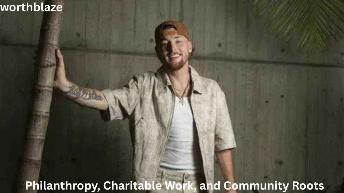 Bailey Zimmerman smiles while standing beside a tree, highlighting his philanthropy, charitable work, and community involvement. The image reflects the success behind Bailey Zimmerman Net Worth and his commitment to giving back.