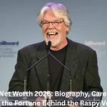 Bob Seger smiling while speaking at an event podium, highlighting the topic of Bob Seger Net Worth 2026 and his successful music career.