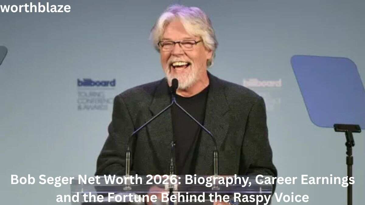 Bob Seger smiling while speaking at an event podium, highlighting the topic of Bob Seger Net Worth 2026 and his successful music career.