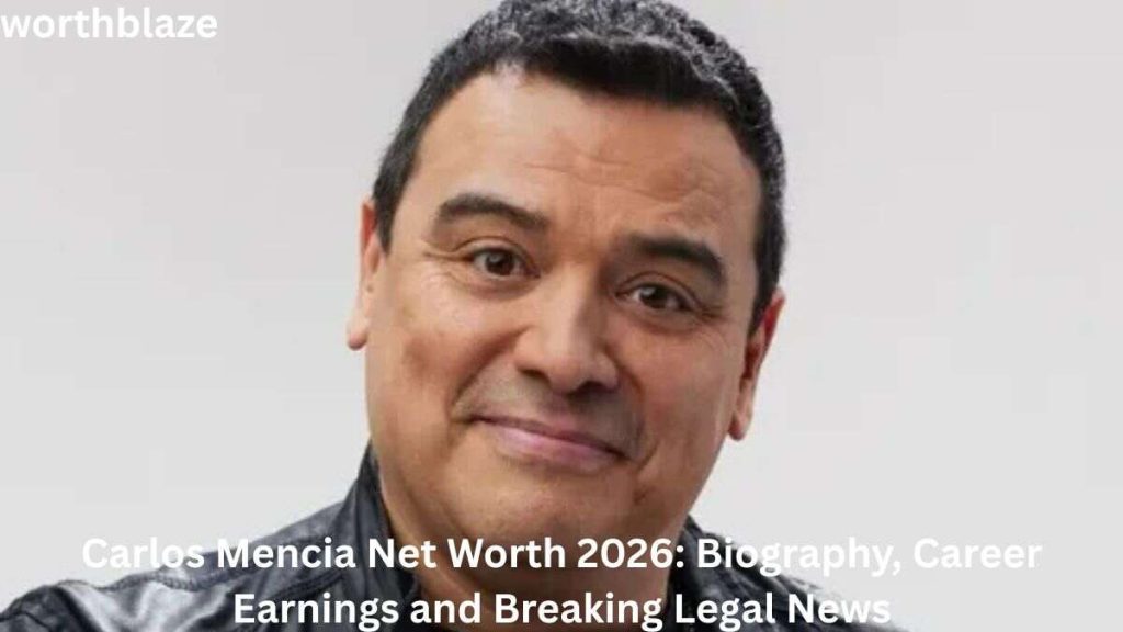 Carlos Mencia smiling in a close-up portrait, wearing a black leather jacket, featured in an article about Carlos Mencia Net Worth, career earnings, biography, and legal news.