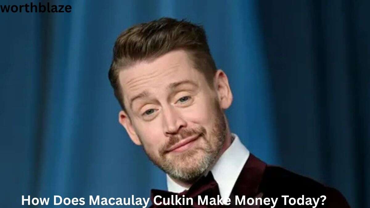 Macaulay Culkin in a formal suit at a public event, representing Macaulay Culkin Net Worth and the various ways he earns money today through entertainment and business ventures.