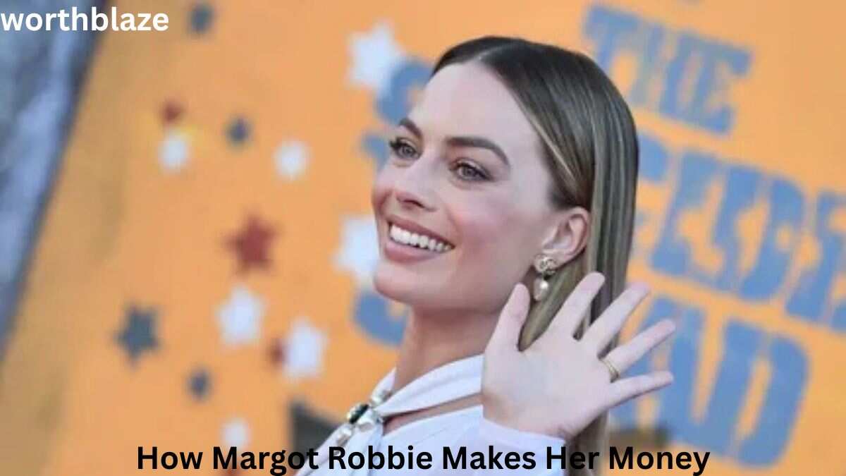 Margot Robbie smiling and waving at a movie premiere event, highlighting how her acting career, production projects, and endorsements contribute to Margot Robbie Net Worth.