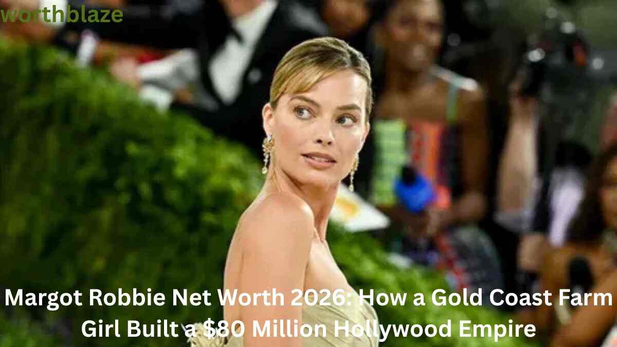 Margot Robbie posing at a red carpet event, showcasing the success and fame behind her growing net worth.