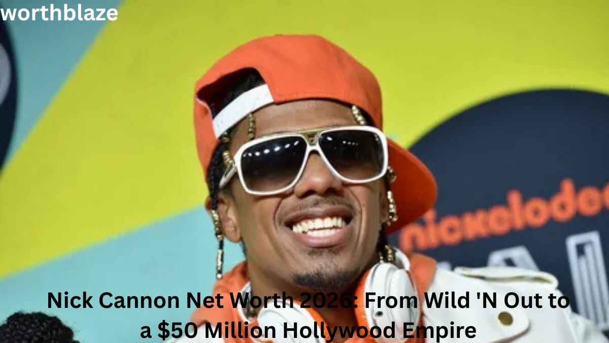 Nick Cannon smiling at a public event while wearing an orange cap, white sunglasses, and headphones, featured in an article about Nick Cannon Net Worth and his entertainment career success.